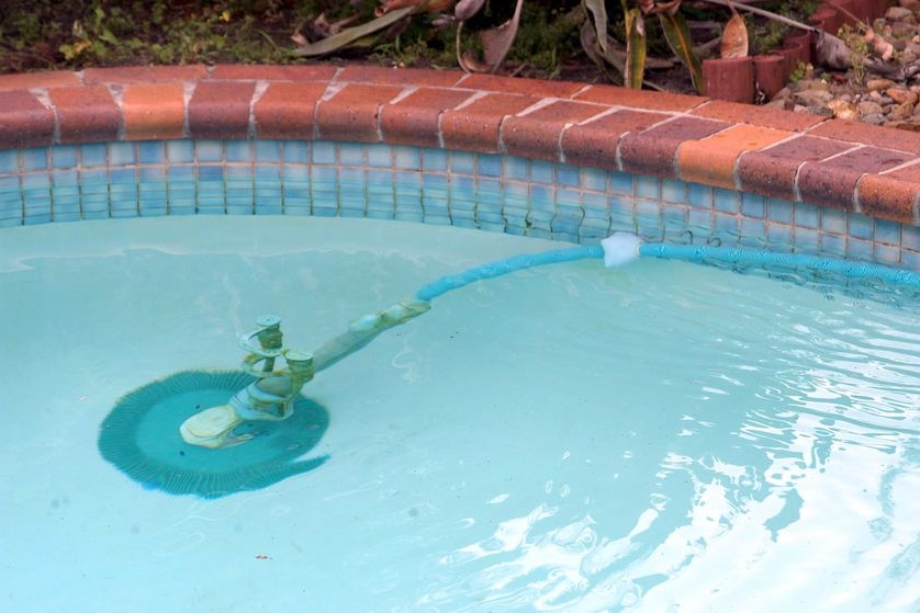 A Kreepy Krauly makes its way around a swimming pool