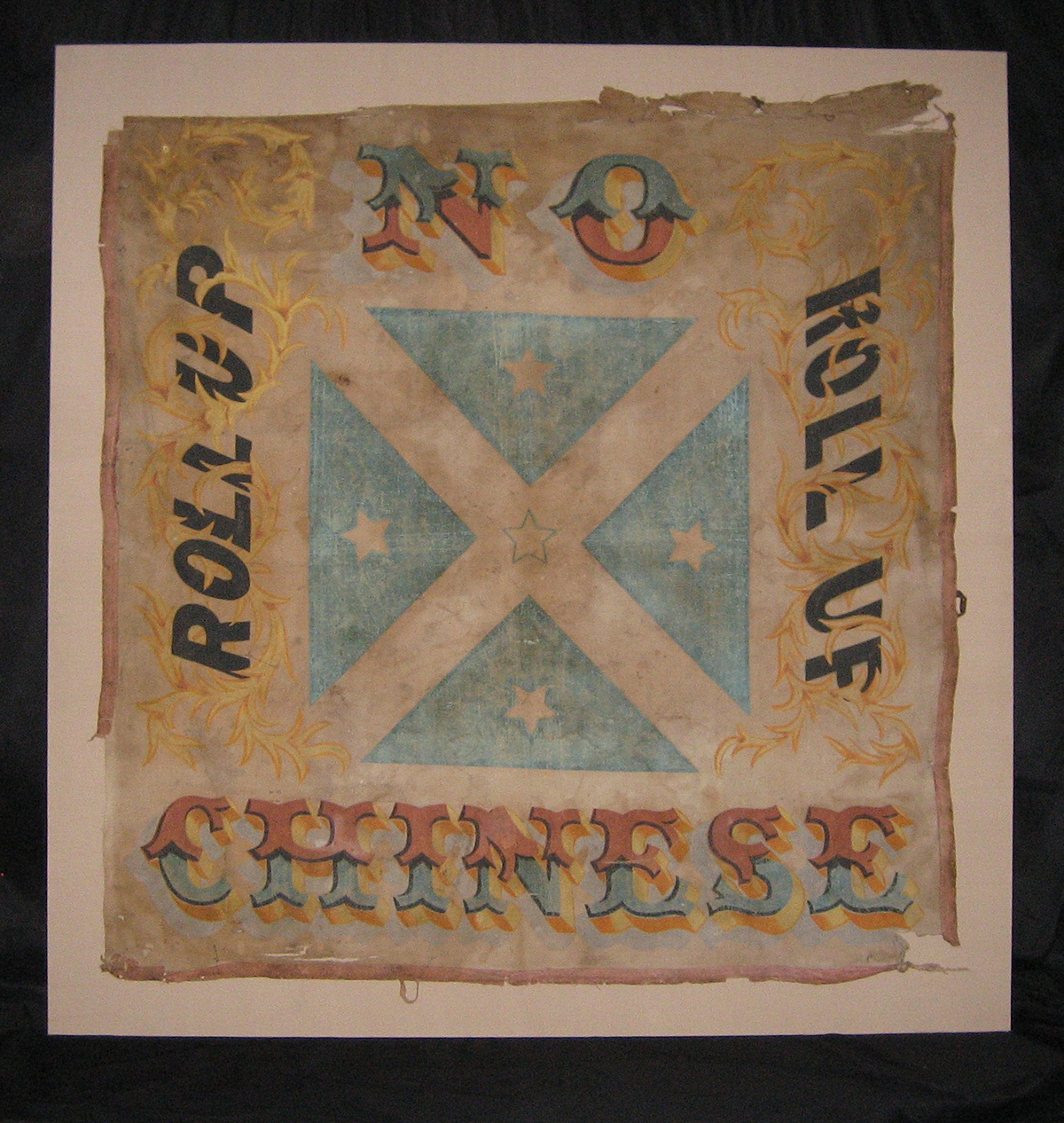 Colour scan of the Roll Up Banner used during the Lambing Flat Riots, it reads “Roll Up, Roll Up, No Chinese”.