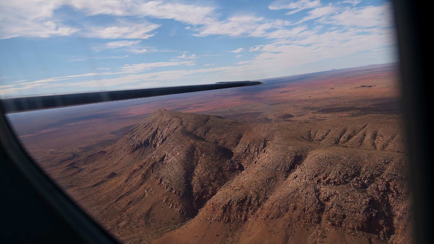 The Centipede Dreaming landscape of rolling deser hills on the flight from Haasts Bluff to Alice Springs is seen from the plane