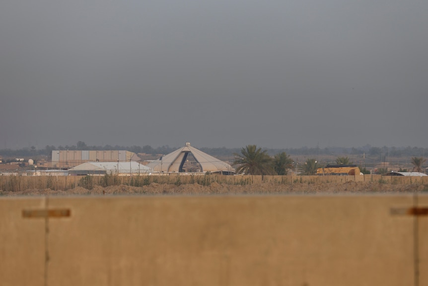 Large tents behind empty blocks of land. 