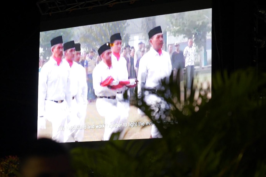 A video of a man holding the Indonesian flag 