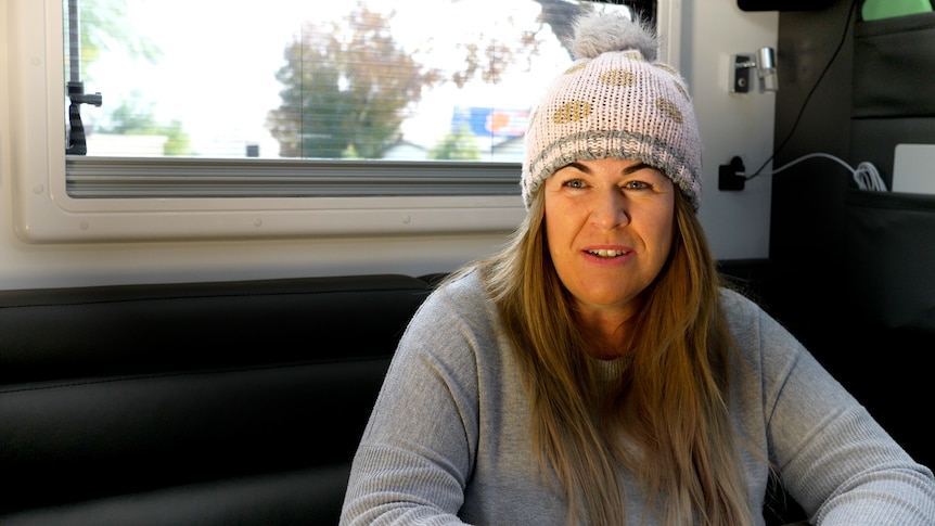 Woman with long hair wearing a beanie
