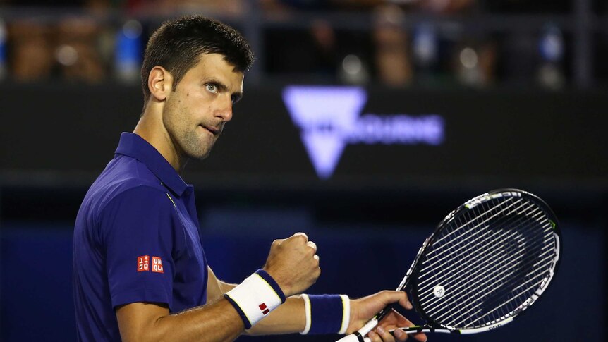 Serbia's Novak Djokovic celebrates point won against Roger Federer in Australian Open semi-final.