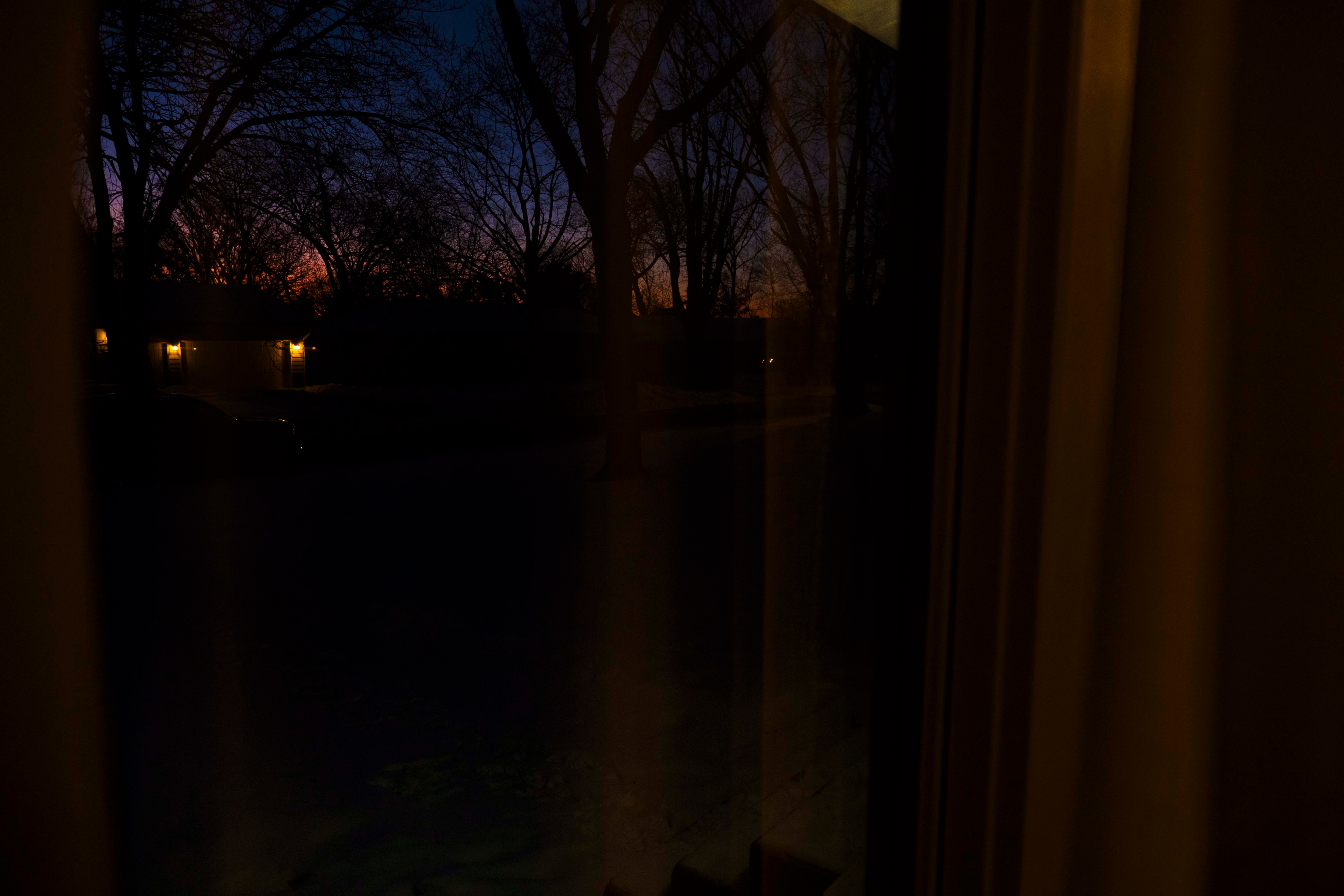 The end of a sunset, seen through a window inside a home.