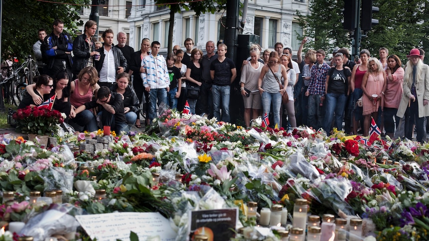 People gather outside the Oslo Cathedral to mourn and pay their respects.