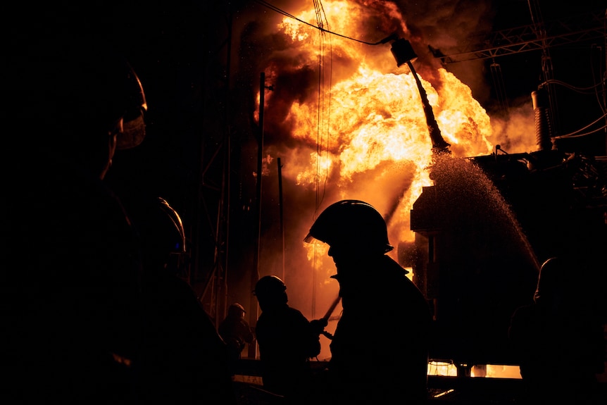 Fire blazes in the darkness as firefighters put out blaze in Ukraine.