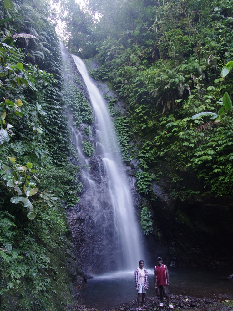 Kolombangara Islanders Mofat and Jenny at one of the many waterfalls deep inside the Kolombangara Island crater, Patu Kolo