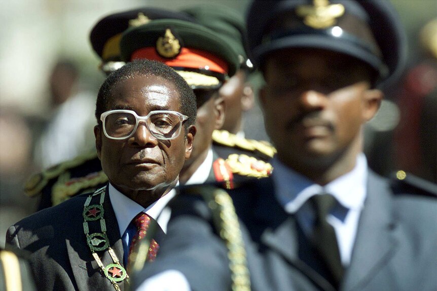 Robert Mugabe sternly inspects troops in 2000.