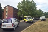An ambulance leaves Stuart Flats in Canberra after a male was found dead.