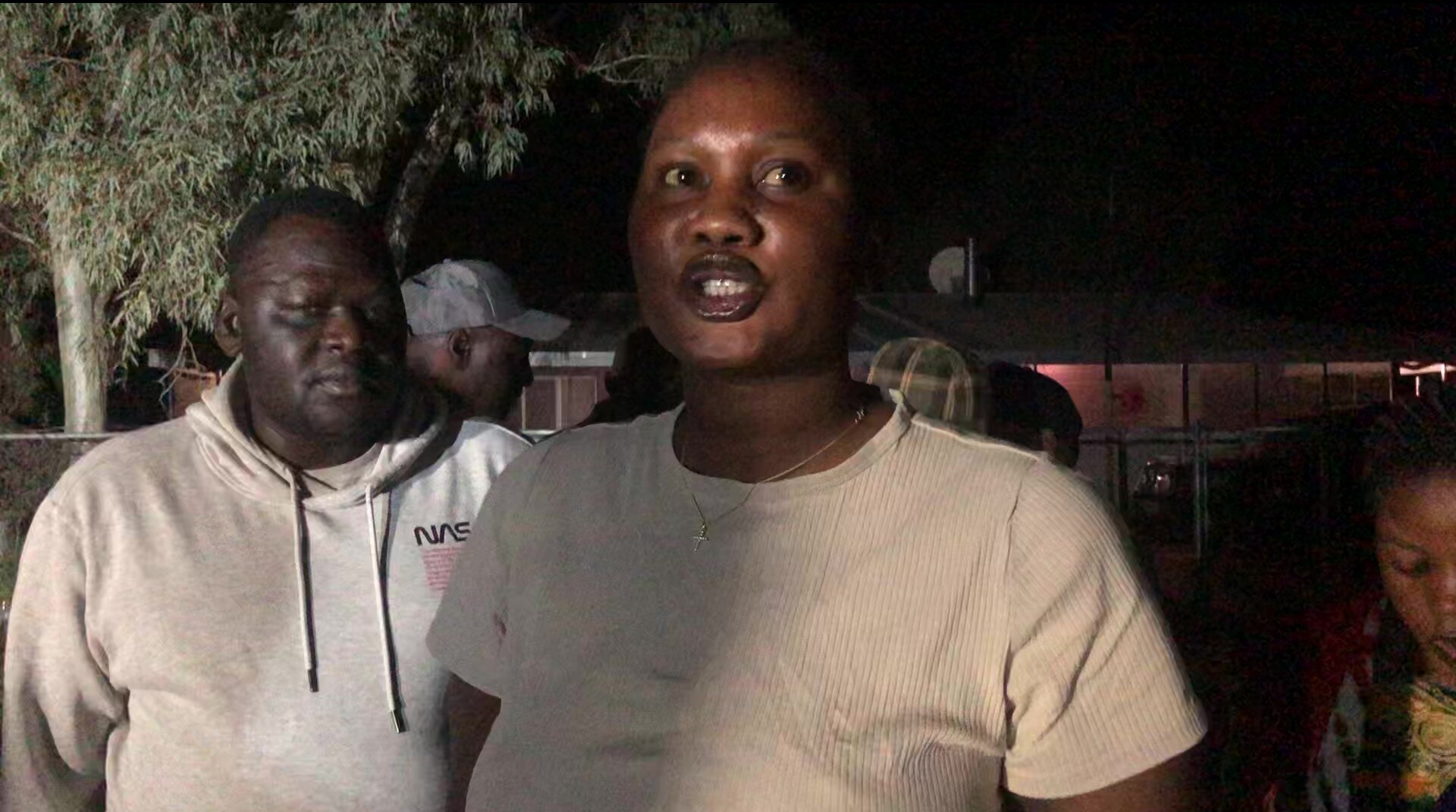 A woman speaking to a journalist.