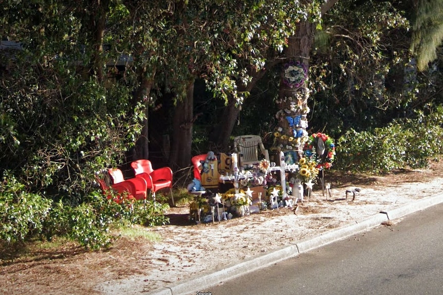 A colourful roadside memorial to the victims of a car crash