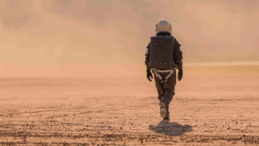 Astronaut walking in space suit.