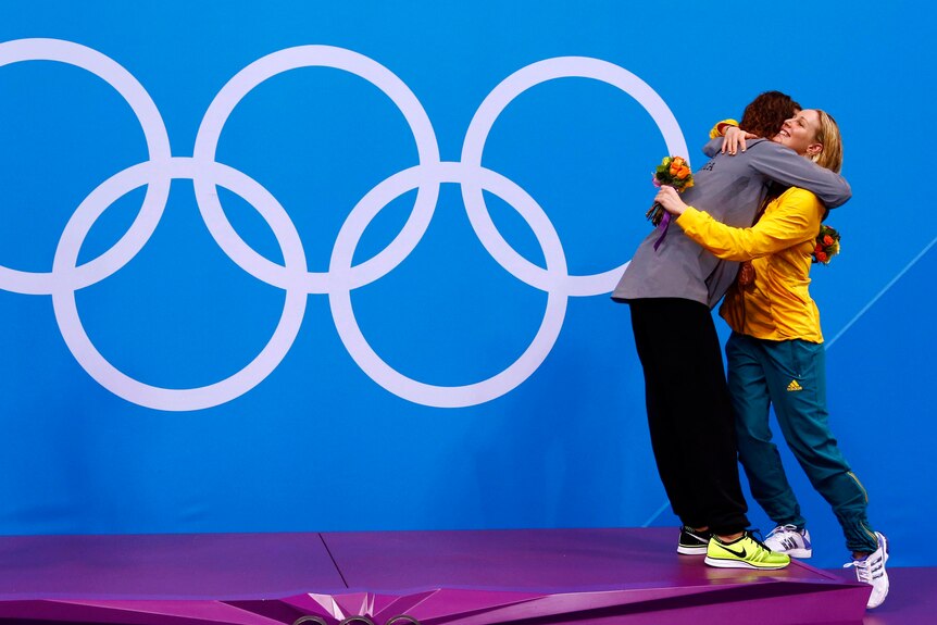 Allison Schmitt hugs bronze medallist Bronte Barratt during the 200m freestyle victory ceremony.