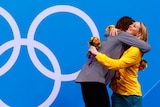 Allison Schmitt hugs bronze medallist Bronte Barratt during the 200m freestyle victory ceremony.