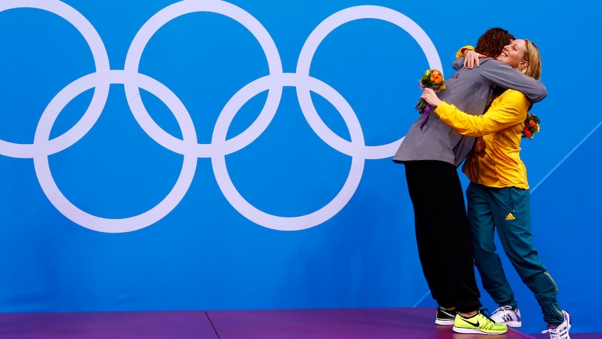 Allison Schmitt hugs bronze medallist Bronte Barratt during the 200m freestyle victory ceremony.