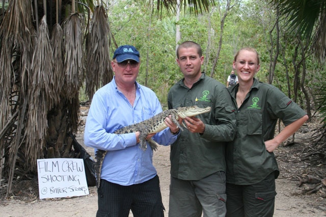 John Stainton holds a baby croc