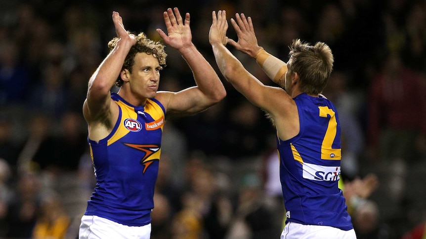 On top ... Matt Priddis celebrates a goal with Mark LeCras