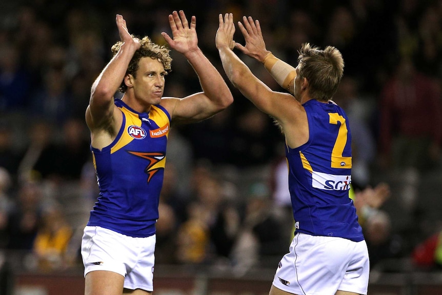 Matt Priddis of the Eagles celebrates a goal with Mark LeCras.