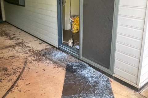door broken with glass on the floor 