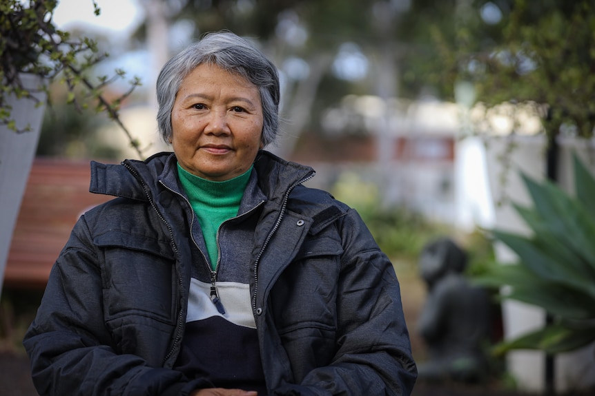 A smiling woman with short grey hair