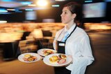 A waitress carries plates with food