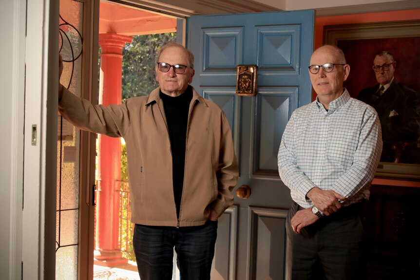 Roy Dixon and John Nowlan stand inside the entrance of the Lindenfels house.