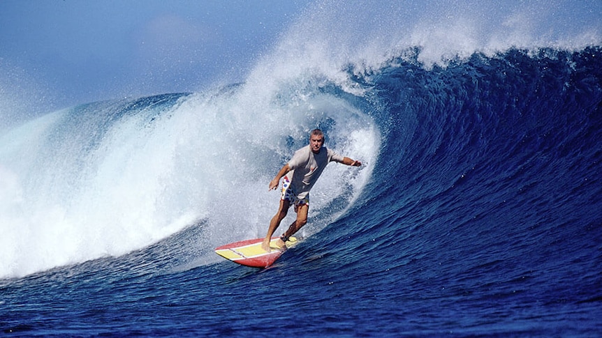 Phil Jarratt surfs big wave.