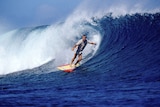 Phil Jarratt surfs big wave.