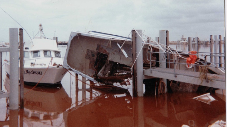 A boat in a pen that lost its mooring and crashed into a jetty.