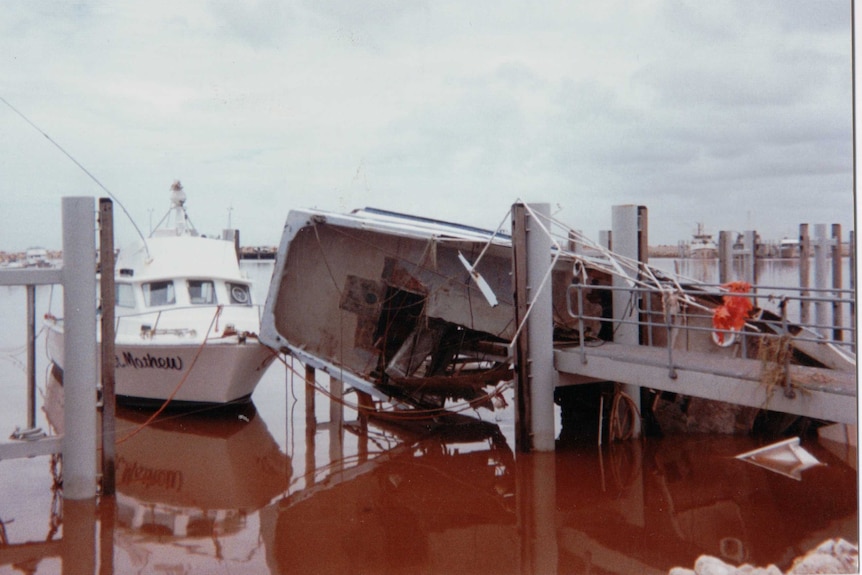 A boat in a pen that lost its mooring and crashed into a jetty.