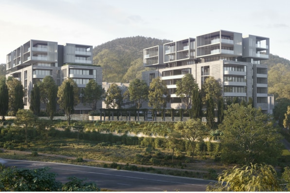 An artist's rendering of a proposed development shows several multi-storey apartments at the base of a mountain.