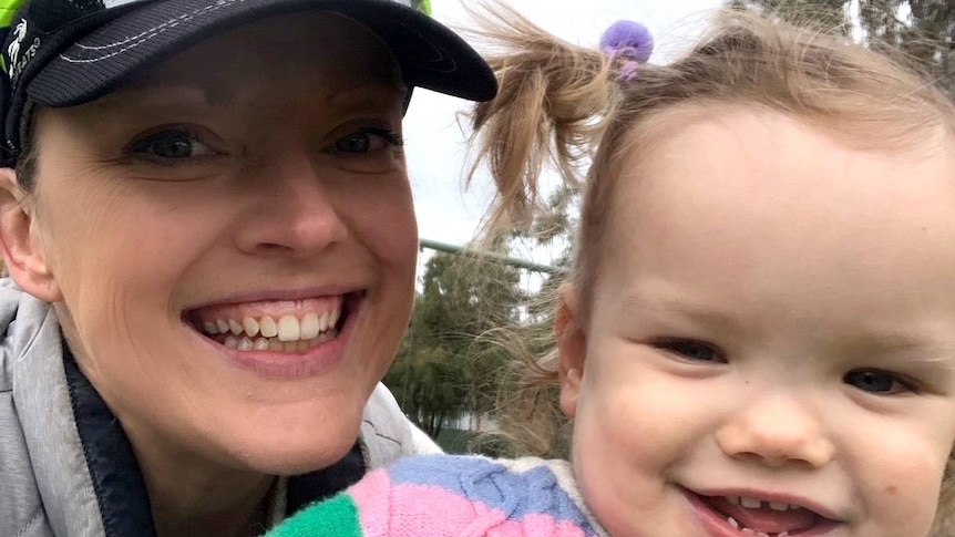 A woman in a cap with her daughter.