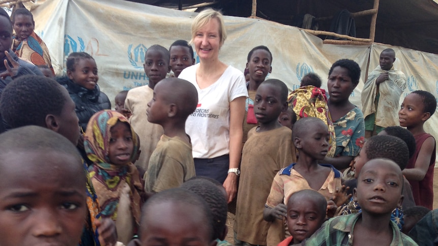 Dymphna Halls-Smith surrounded by children in the Tanzania camp.