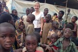 Dymphna Halls-Smith surrounded by children in the Tanzania camp.