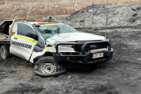 A white ute after being crushed by heavy machinery at a coal mine.
