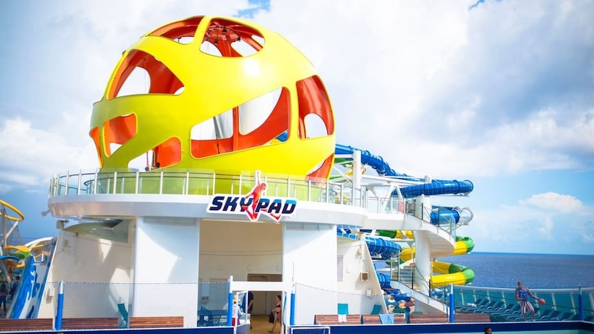 A large yellow ball on top of a cruise ship.