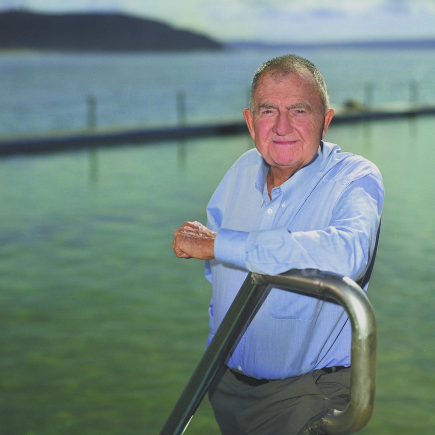 A portrait of Forbes Carlile by a swimming pool.