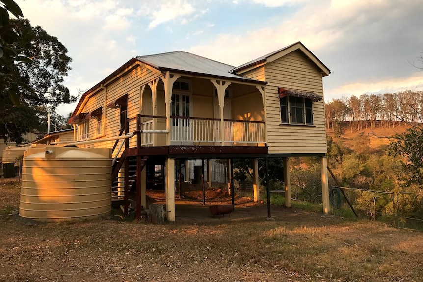 Old yellow house up on stilts.