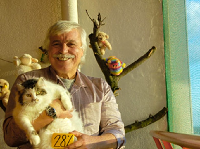 One of the residents from Berlin 100% with his cat showing his 28% sign.
