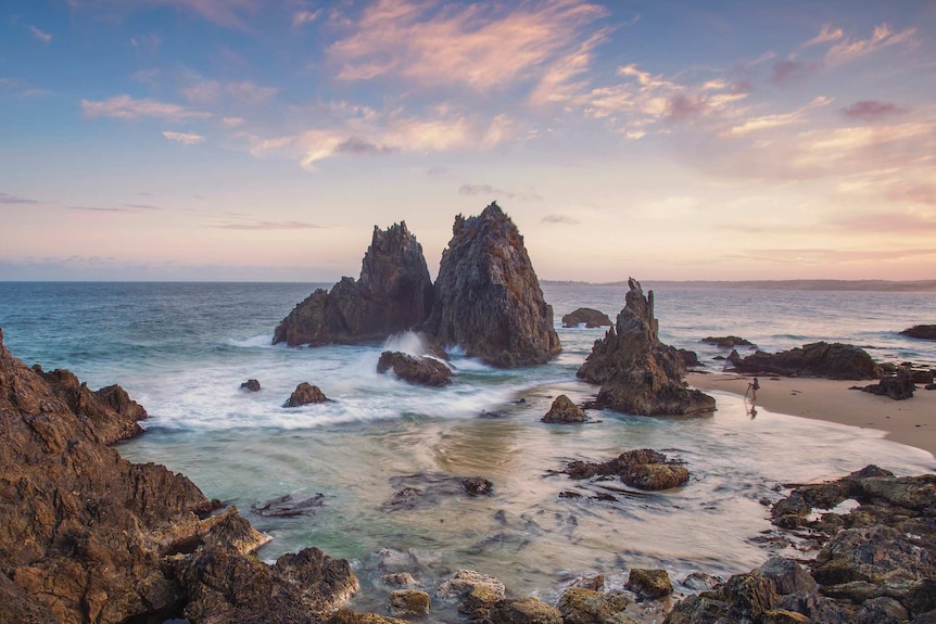 A rock formation jutting out of the sea