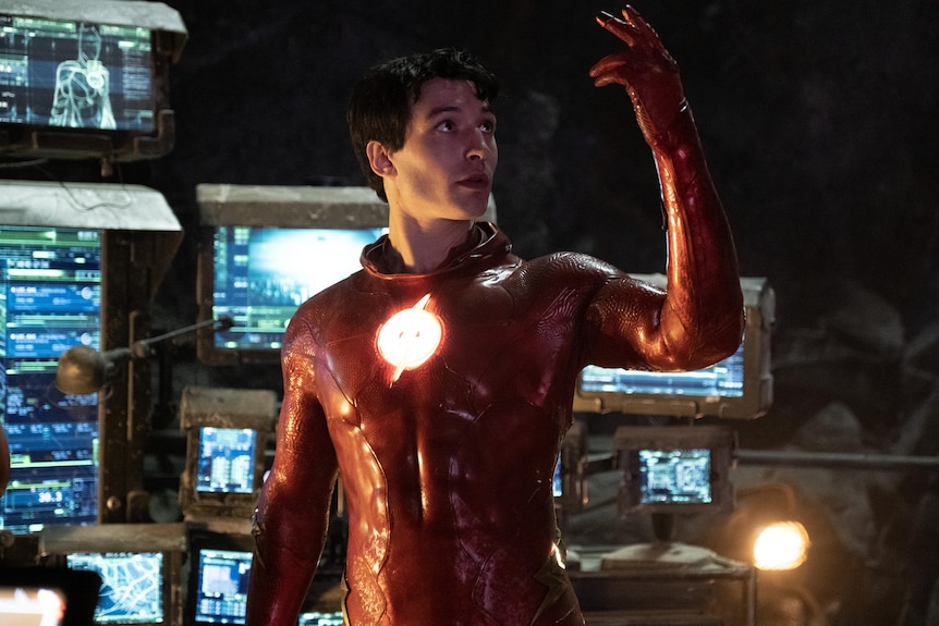 Barry, a white man with dark hair, is dressed as The Flash in red spandex with a glowing red chest.