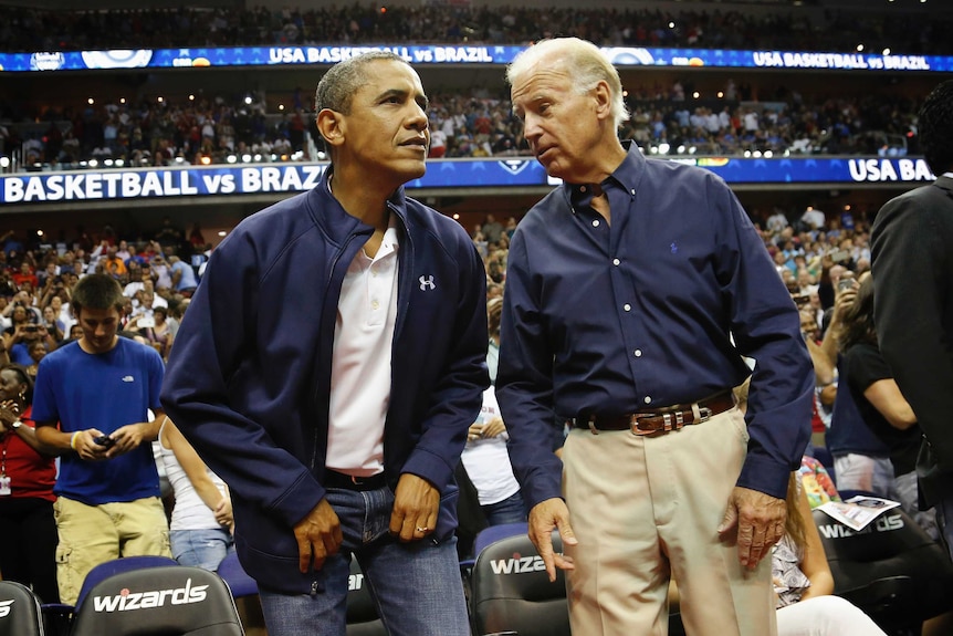 US President Barack Obama and Vice President Joe Biden take their seats for an Olympic basketball exhibition game between the US and Brazil national men's teams in Washington.