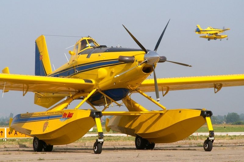 Two amphibious water scooper fire fighting aircraft.