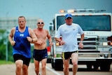 Runners from Tour of Duty 2010 make their way along a road