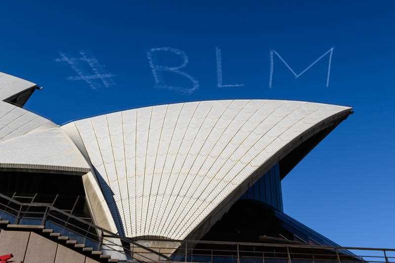 #BLM is written in skywriting over the Sydney Opera House.
