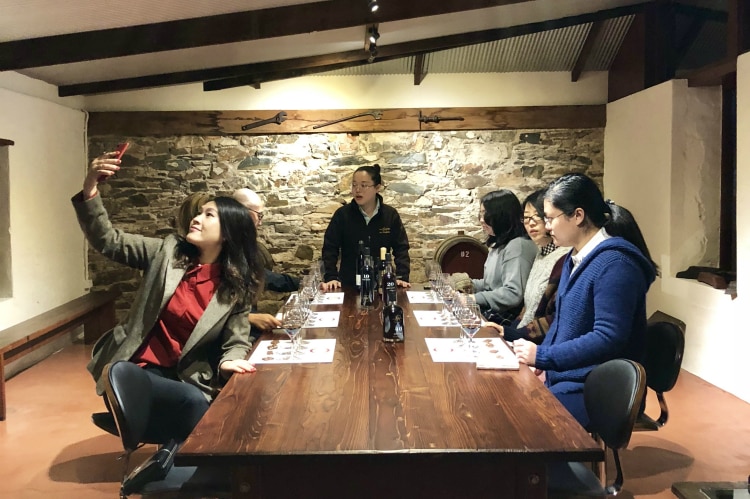 Chinese visitors sit at a tasting table at Chateau Yaldara.