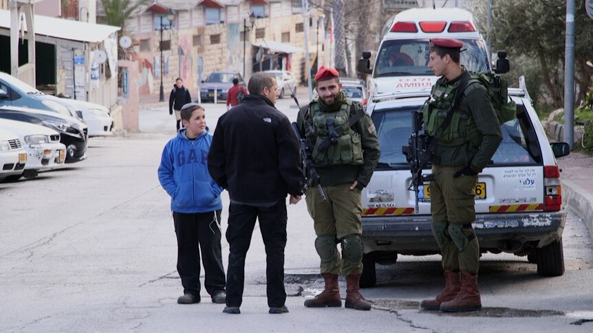 Civilians talk to two IDF soldiers