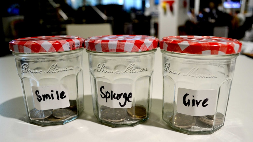Three jams jars, each with a label reading "smile", "splurge" or "give.