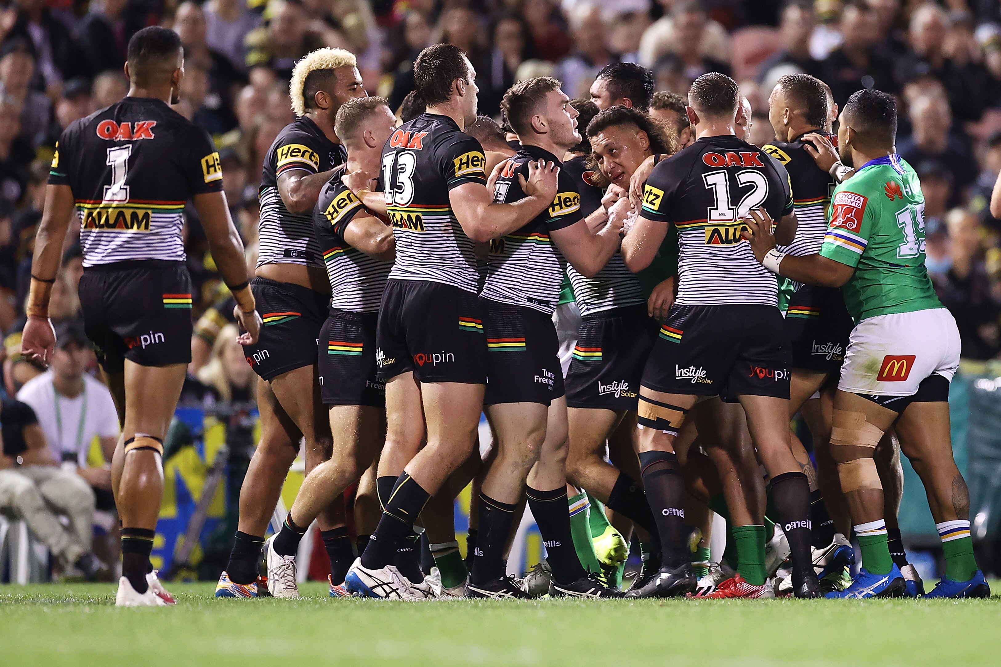 Two rugby league teams engage in a scuffle
