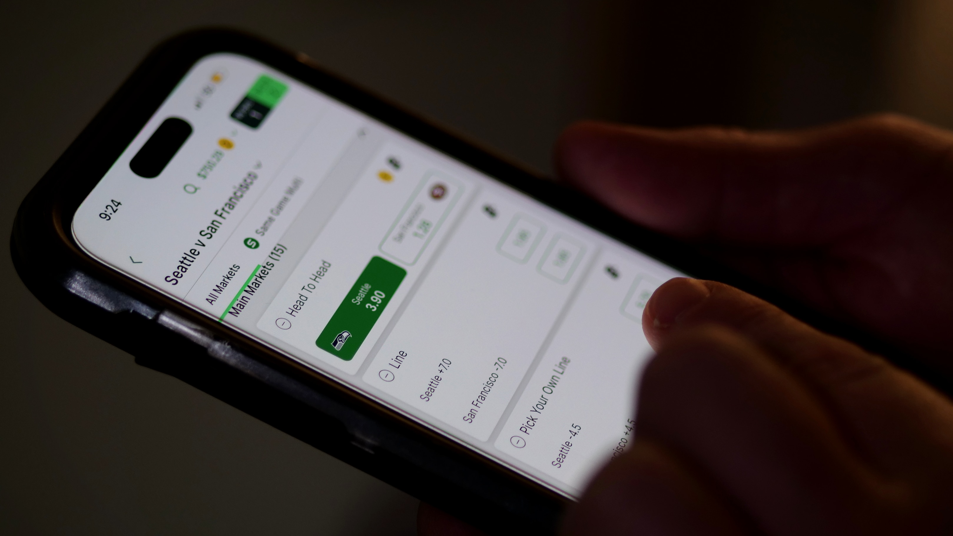Close up of phone with someone about to place a bet on a sports game